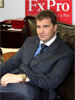 Photo of Denis seated in office